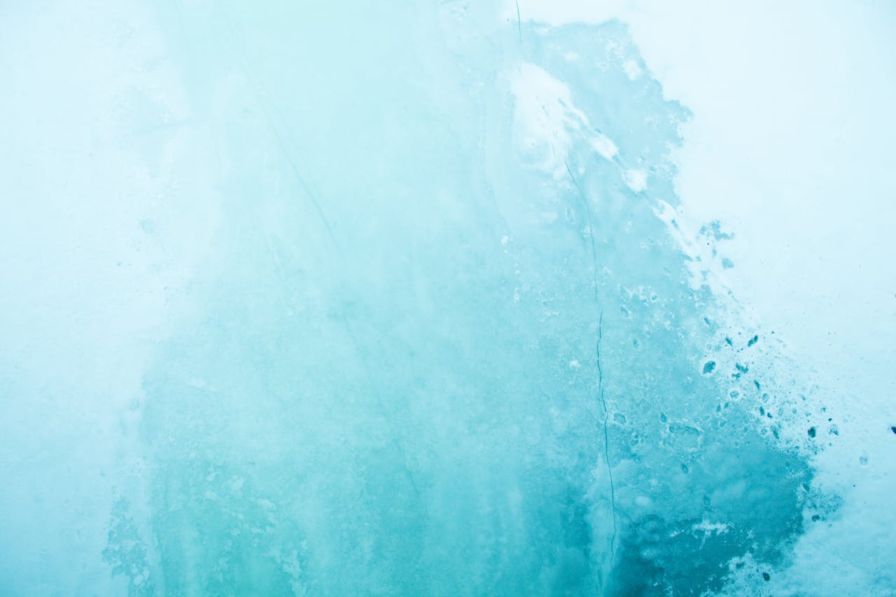 Abstract light blue texture with rough concrete surface and crack details, ideal for design use.